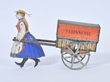 toy figurine of a woman pulling a cart with a sign on it