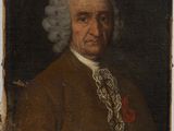 portrait of a man in a brown coat and white hair