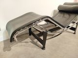 an image of a black leather chaise lounger and ottoman