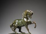 an image of a bronze statue of a horse on a wooden base