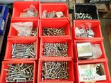 many different types of screws and nuts in red bins