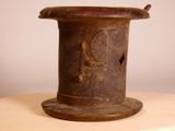 a small brown vase sitting on top of a wooden table