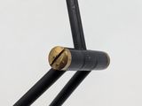 a close up of a pair of black wires connected to a metal pole