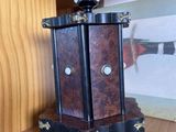 a wooden shelf with a clock on it and a picture on the wall