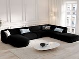 a large black couch in the middle of a living room