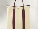un sac fourre-tout blanc et marron posé sur une table blanche