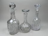 three glass vases sitting next to each other on a table