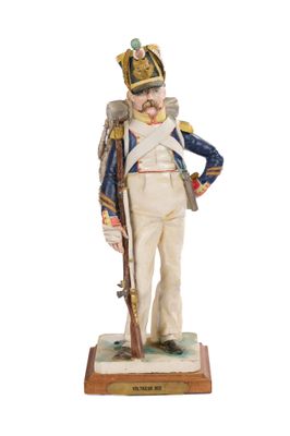figurine of a man in a military uniform with a rifle