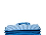 a blue purse sitting on top of a stack of books