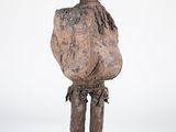 an old wooden statue of a man with a hat on his head