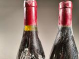 two bottles of wine that are sitting on a table