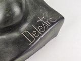 a close up of a statue of a dog with a name on it