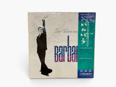 a white album with a picture of a man in a suit and tie