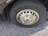 a black car that has a flat tire on it