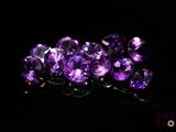 purple amethorate faceted beads on a black background