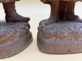 two statues of elephants that are standing on top of each other