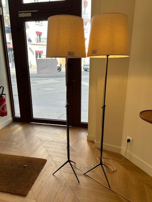 two lamps that are on a stand in a room