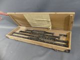 an image of a wooden box with a set of rulers in it