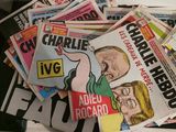 a pile of newspapers sitting on top of a table