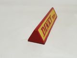 a small red and yellow sign on a white surface