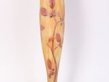 un vase orné d'une fleur, posé sur un socle
