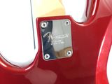 the back end of a red electric guitar with a white background