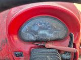 a close up of a red motorcycle with a speedometer on it