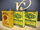 three cans that are sitting next to each other on a table