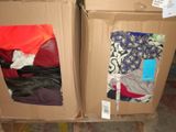 two boxes that have clothes in them on the floor