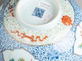 a blue and white bowl with a floral design on it