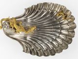 a silver shell with a gold dragon on it