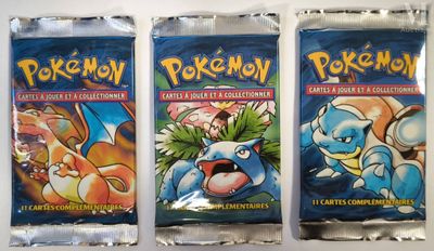 three packs of pokemon trading cards sitting on top of each other