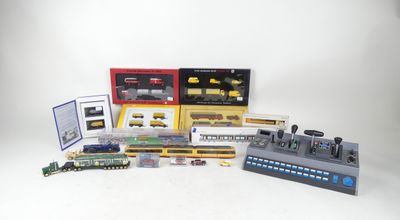 a lot of different model trains and accessories on the table