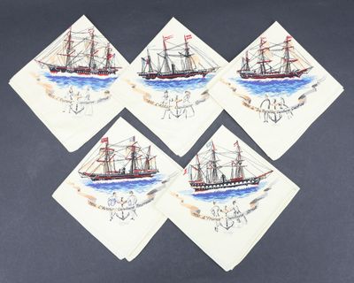 four napkins with drawings of ships on them on a table