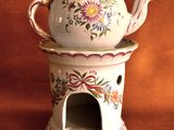 a white teapot with a spoon in it on a table
