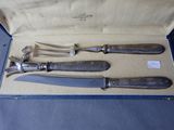 three knives in a box on a table