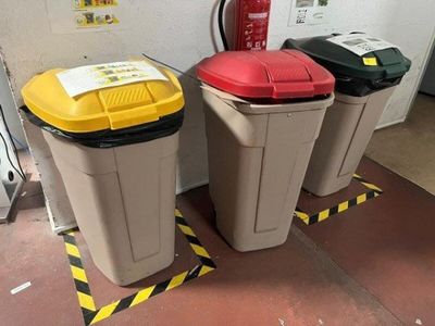 three trash cans sitting next to each other on the floor