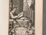 an open book with a picture of a man reading a book