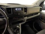 a dashboard of a car with a digital clock on it