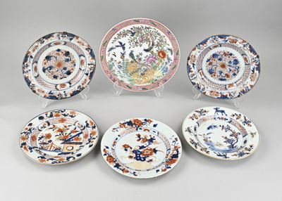 six plates with different designs on them sitting on a table