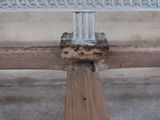 a close up of a wooden bench with rust on it