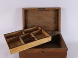 an old wooden box with two compartments open on a white surface