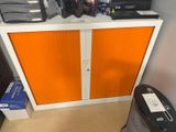 a cabinet with a bunch of electronics on top of it