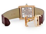 a brown strap around the wrist of a watch