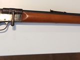 a rifle that is on display on the wall