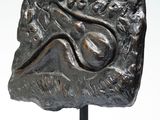 an image of a sculpture of a rock with a face on it