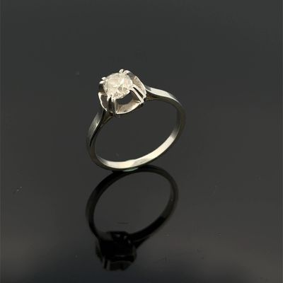 a close up of a silver ring on a black surface