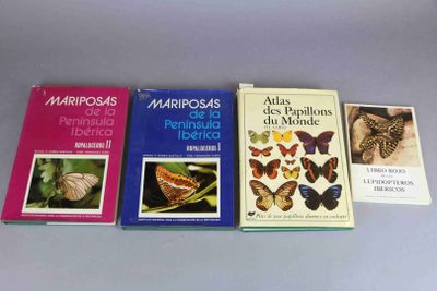 four books of different kinds of butterflies are lined up on a table