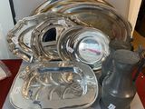 a silver tray and a silver pitcher sitting on a table