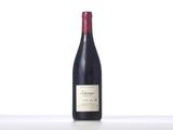 the bottle of red wine is sitting on the table
